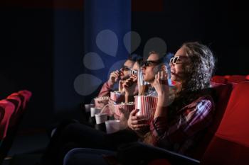 Friends watching movie in cinema�