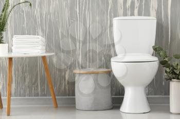 Modern interior of restroom with ceramic toilet bowl�