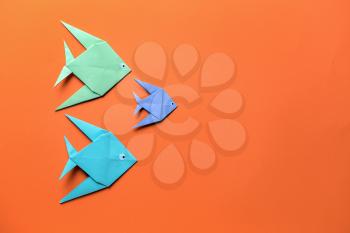 Origami fish on color background�