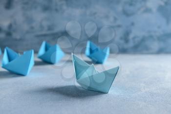 Origami boats on color table�