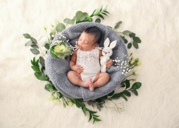 Cute African-American baby on light furry background�