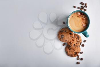 Composition with cup of hot coffee and cookies on light background�