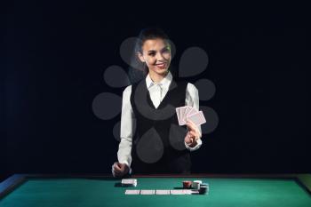Beautiful female banker at table in casino�