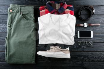 Set of stylish male clothes and accessories on wooden background�