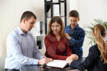Divorced parents with their son visiting lawyer. Concept of child support�