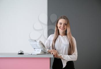 Female receptionist near desk in hotel�