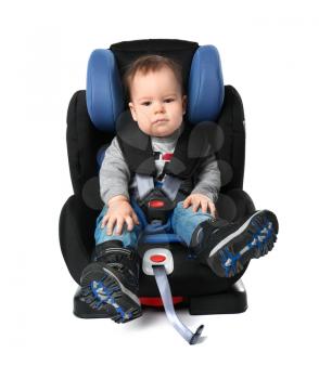 Baby boy buckled in car seat on white background�