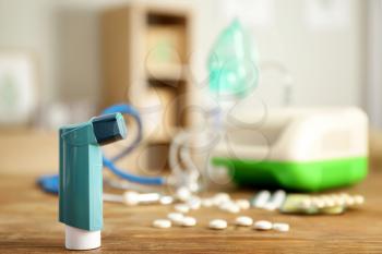 Inhalers with pills on table at home�