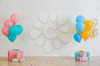 Birthday balloons with gift boxes in room�