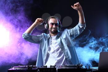 Male DJ playing music in club�
