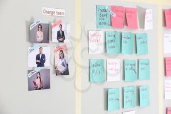 Scrum task board with stickers on wall in office�