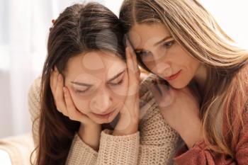 Friend helping young depressed woman at home. Stop a suicide�