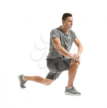 Sporty young man training against white background�