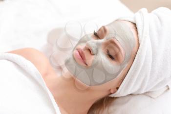 Young woman with facial mask in beauty salon�