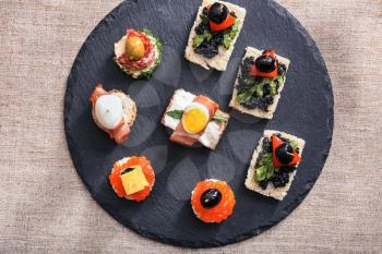 Tasty canapes on slate plate�