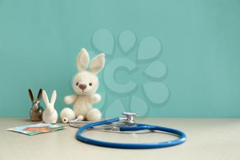 Toy bunnies with stethoscope on table�
