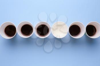 Cups with water and coffee on color background. Concept of uniqueness�
