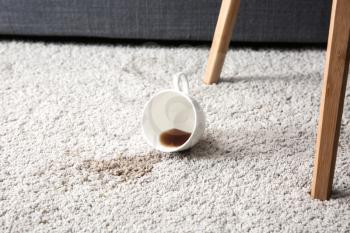 Cup of coffee spilled on carpet�