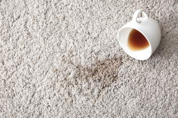 Cup of coffee spilled on carpet�