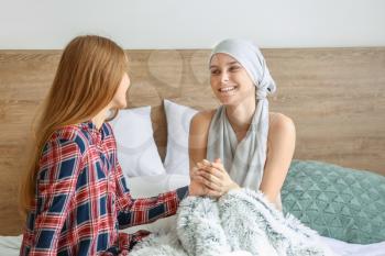 Woman supporting her sister after chemotherapy at home�
