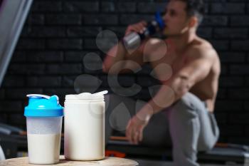 Protein shake on table against dark background�
