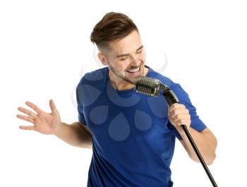 Handsome male singer with microphone on white background�