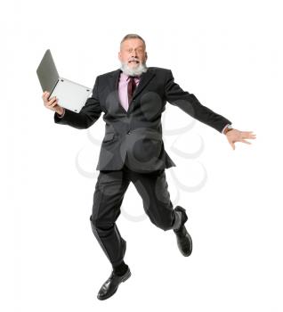 Jumping mature man with laptop on white background�