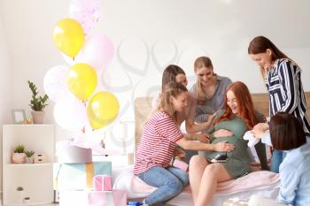 Beautiful pregnant woman and her friends at baby shower party�