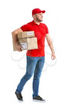 Handsome delivery man with boxes on white background�