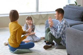 Deaf mute family using sign language at home�