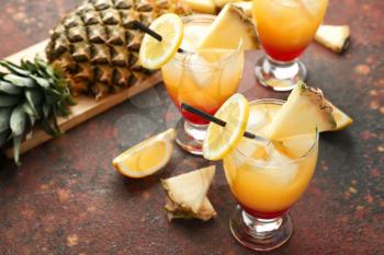 Glasses of Tequila Sunrise cocktail on table�