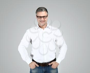 Portrait of stylish mature man on grey background�