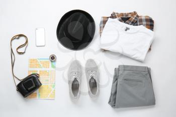 Stylish male clothes with photo camera, mobile phone, map and compass on white background. Travel concept�