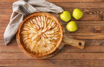 Tasty apple pie on wooden table�