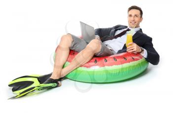 Handsome accountant with cocktail, laptop, paddles and swimming ring dreaming about vacation on white background�