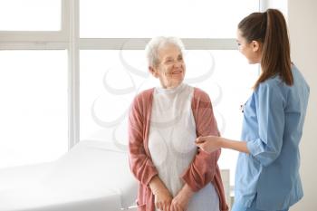 Medical worker with senior woman in nursing home�
