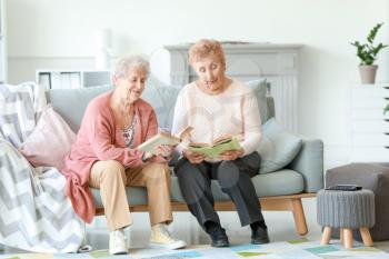 Senior women reading books in nursing home�