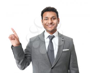 Handsome businessman pointing at something on white background�