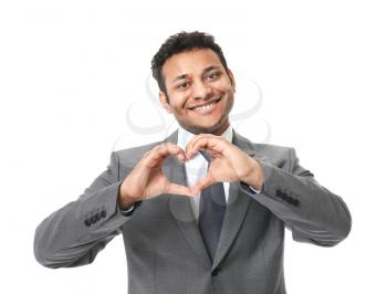 Portrait of handsome businessman making heart with his hands on white background�