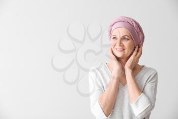 Mature woman after chemotherapy on light background�