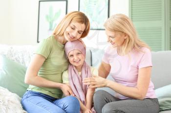 Little girl after chemotherapy with her family at home�