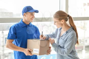 Woman signing documents to confirm receiving of order from delivery company�