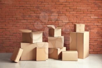Cardboard boxes near brick wall�