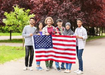 Group of students with USA flag outdoors�