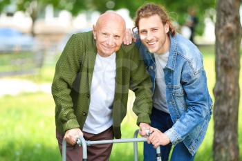 Elderly man with his son in park�