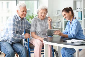 Elderly people with caregiver in nursing home�