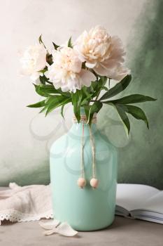 Vase with beautiful peony flowers on table�