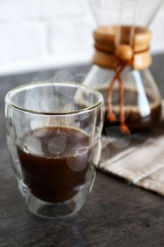 Glass of hot coffee on table�