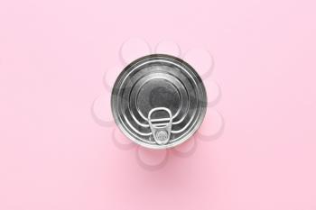 Tin can with food on color background�