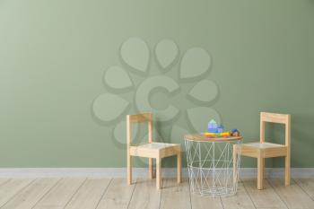 Table and chairs near wall in modern children's room�
